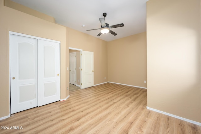 unfurnished bedroom featuring light hardwood / wood-style flooring, a closet, and ceiling fan