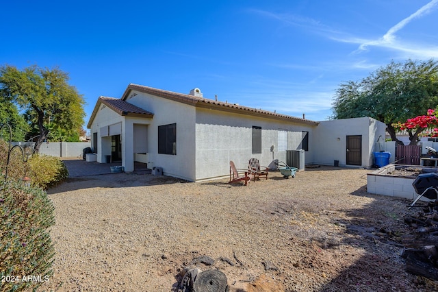 rear view of house with central AC