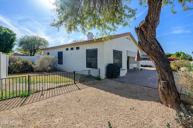 back of house with a patio