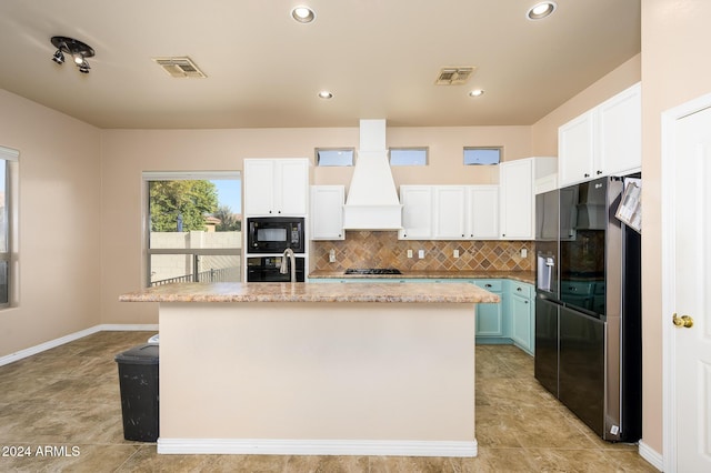 kitchen with an island with sink, white cabinetry, and black appliances