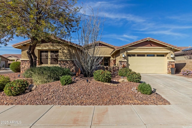 view of front facade featuring a tile roof, stucco siding, concrete driveway, an attached garage, and stone siding