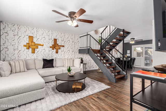 living room with ceiling fan and dark hardwood / wood-style flooring