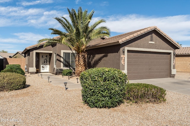 single story home with a garage, a tile roof, driveway, and stucco siding