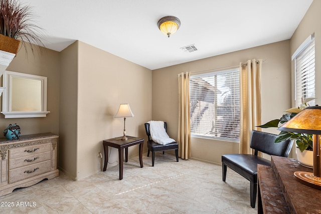 sitting room with baseboards and visible vents