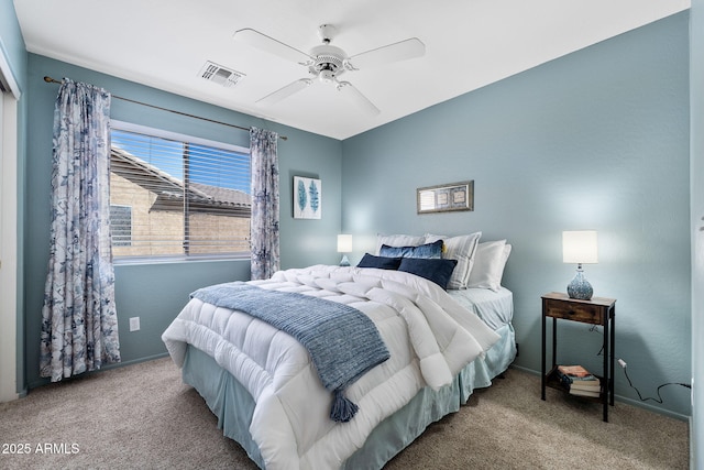 carpeted bedroom featuring ceiling fan and visible vents