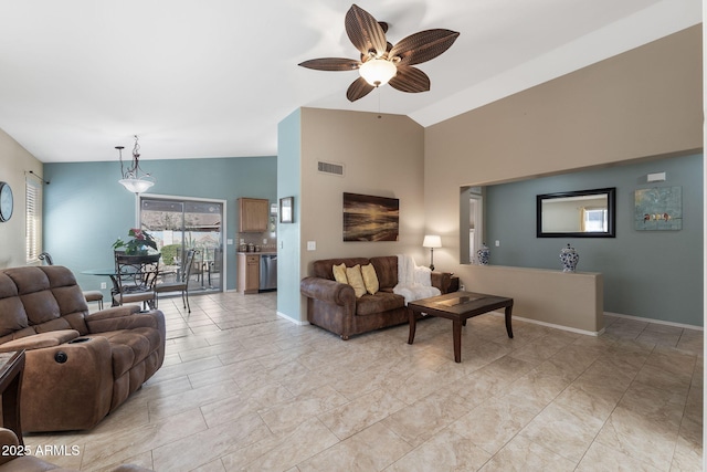 living room with lofted ceiling, visible vents, ceiling fan, and baseboards