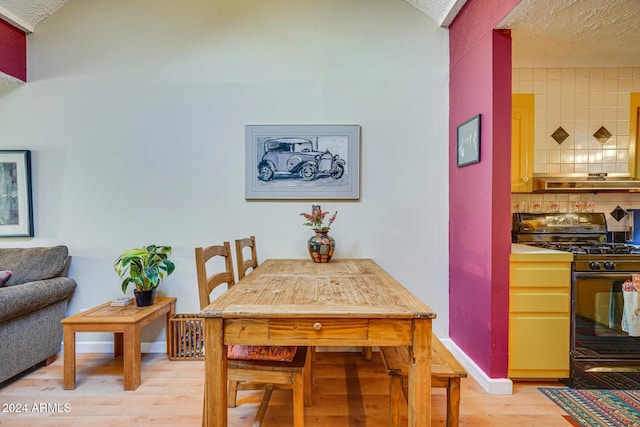 dining space with light wood-style floors and baseboards