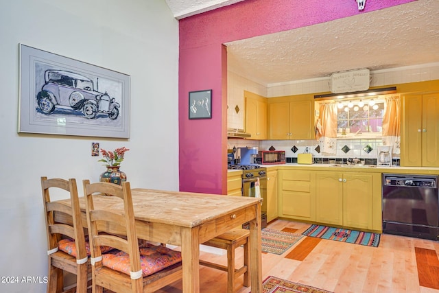 kitchen featuring light wood-style flooring, black dishwasher, a textured ceiling, decorative backsplash, and gas stove