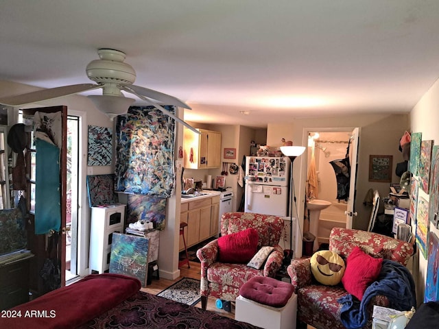 living room with light wood-type flooring and a ceiling fan