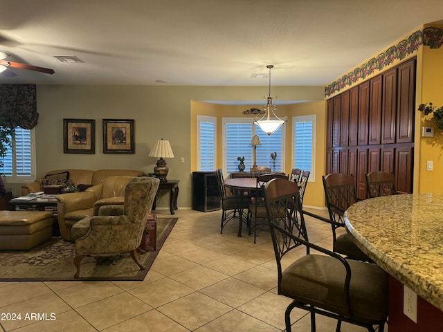 dining space with ceiling fan and light tile patterned floors