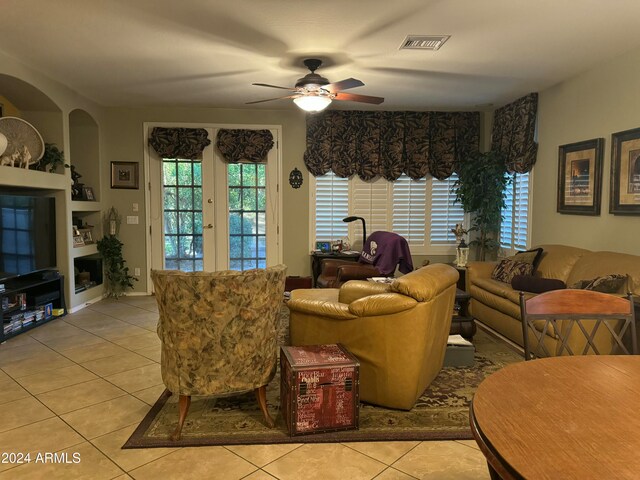 tiled living room featuring ceiling fan