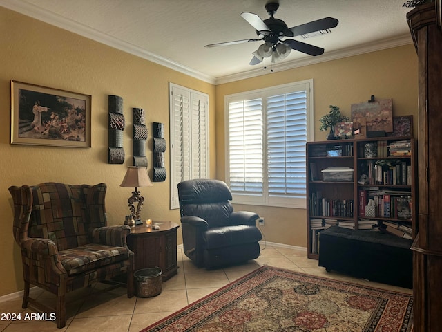 living area with ceiling fan, ornamental molding, a textured ceiling, and light tile patterned floors