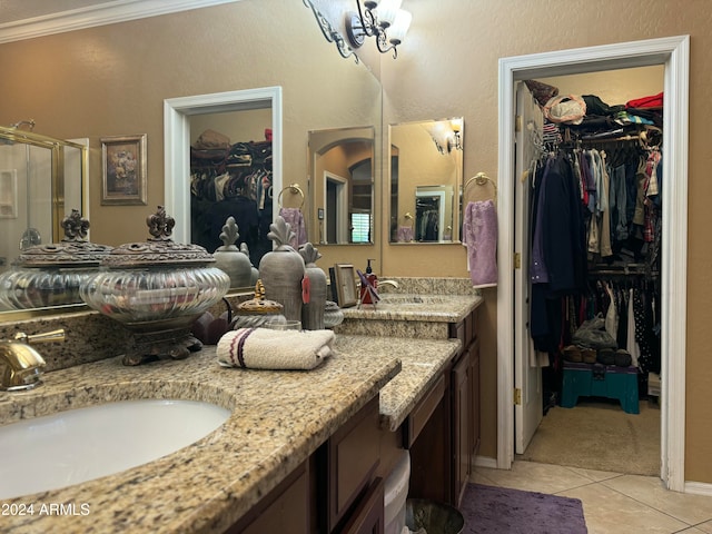 bathroom featuring tile patterned floors, walk in shower, ornamental molding, vanity, and a chandelier