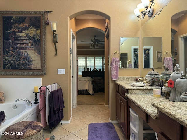 bathroom featuring tile patterned floors, ceiling fan, a bathtub, and vanity