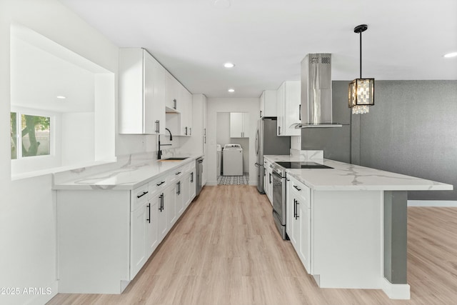 kitchen with kitchen peninsula, white cabinets, stainless steel appliances, and exhaust hood