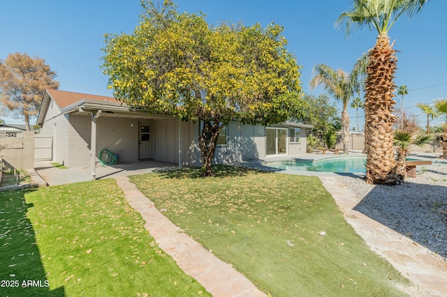 back of house featuring a yard and a patio