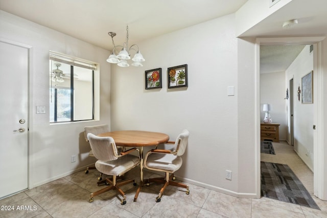 tiled dining area featuring ceiling fan with notable chandelier