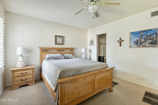 bedroom featuring ceiling fan, a textured ceiling, and multiple windows