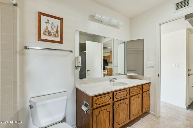 bathroom with tile patterned floors, vanity, and toilet