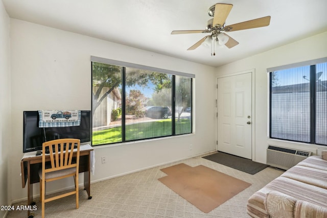 bedroom with ceiling fan, light carpet, and a wall unit AC