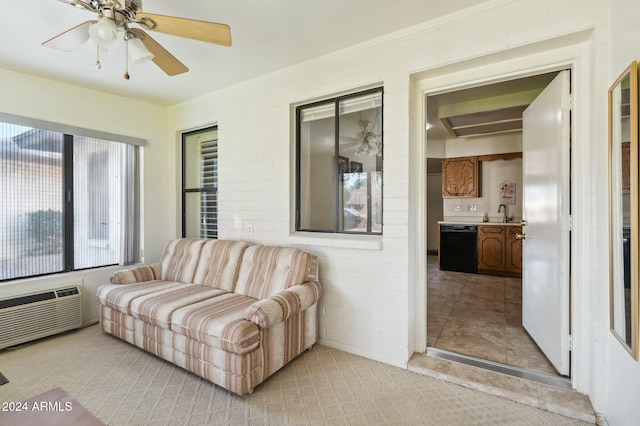 interior space with ceiling fan, sink, and a wall mounted AC