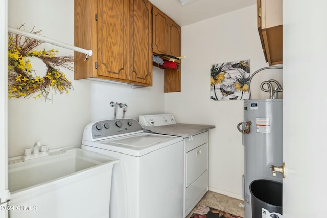 laundry room featuring cabinets, electric water heater, sink, and washing machine and clothes dryer