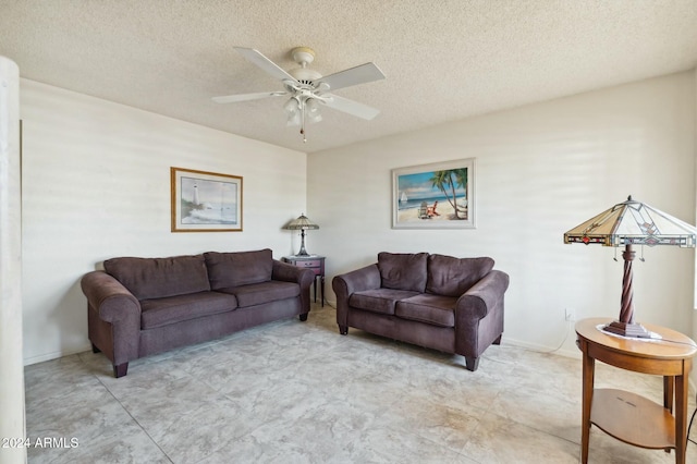 living room with a textured ceiling and ceiling fan