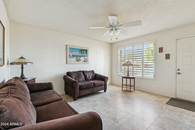 tiled living room featuring ceiling fan and a textured ceiling