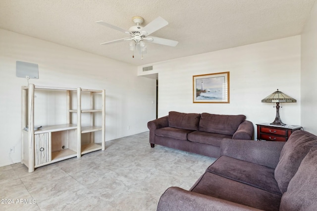 living room featuring a textured ceiling and ceiling fan