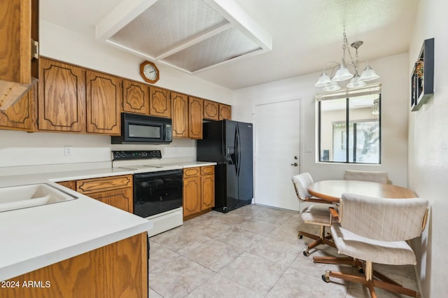 kitchen featuring sink, hanging light fixtures, a chandelier, light tile patterned floors, and black appliances