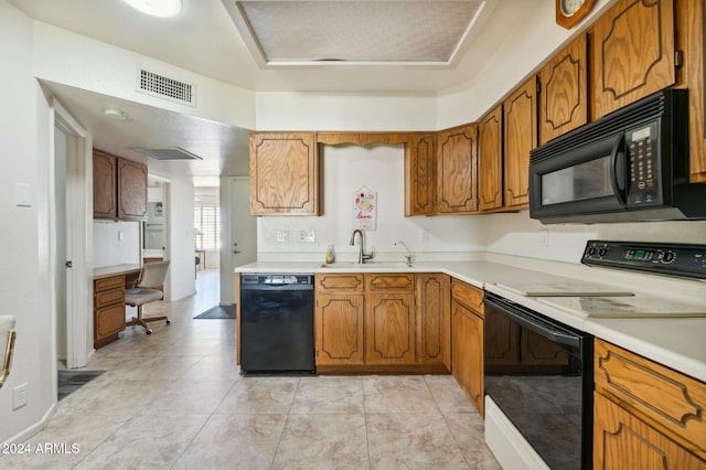 kitchen featuring light tile patterned floors, sink, and black appliances