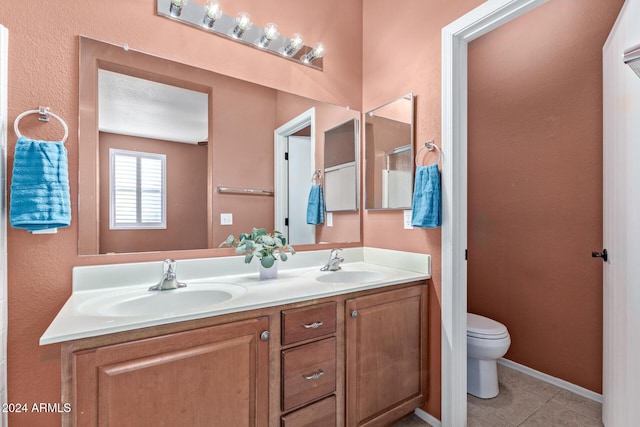 bathroom with vanity, tile patterned flooring, and toilet