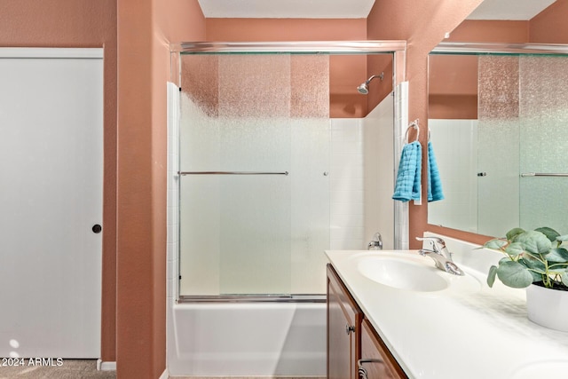 bathroom featuring vanity and shower / bath combination with glass door