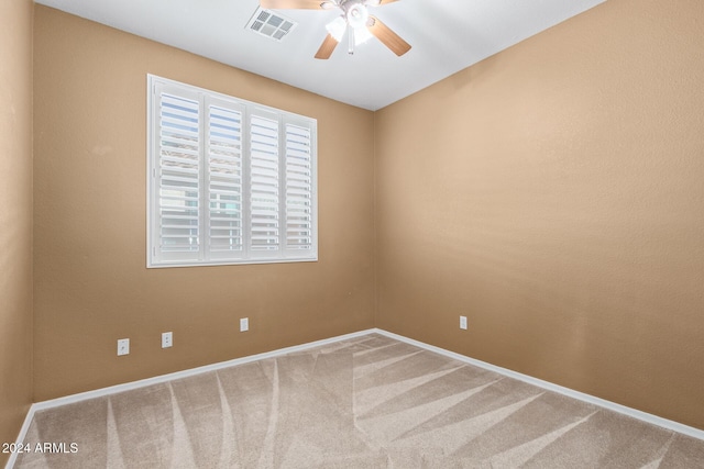 spare room featuring carpet floors and ceiling fan