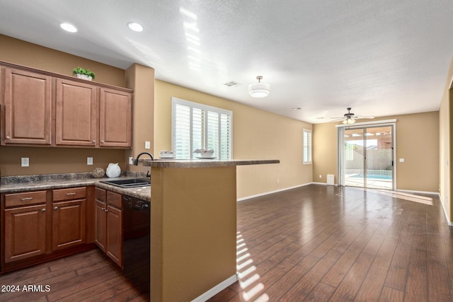 kitchen with sink, plenty of natural light, kitchen peninsula, and dishwasher