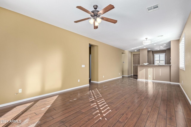 empty room featuring dark hardwood / wood-style flooring and ceiling fan