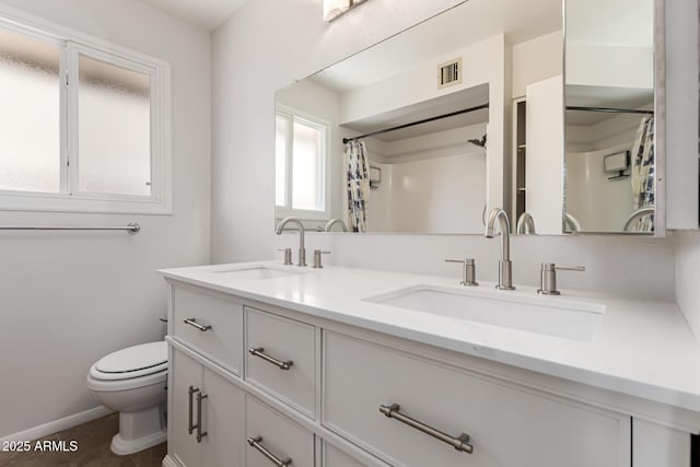 full bathroom with double vanity, toilet, visible vents, and a sink