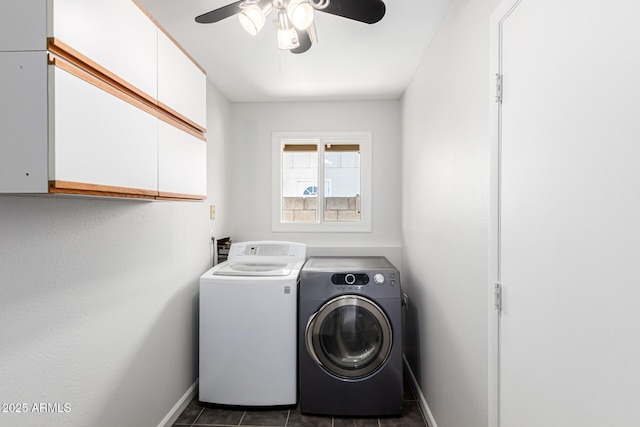clothes washing area featuring baseboards, washer and clothes dryer, dark tile patterned flooring, a ceiling fan, and cabinet space