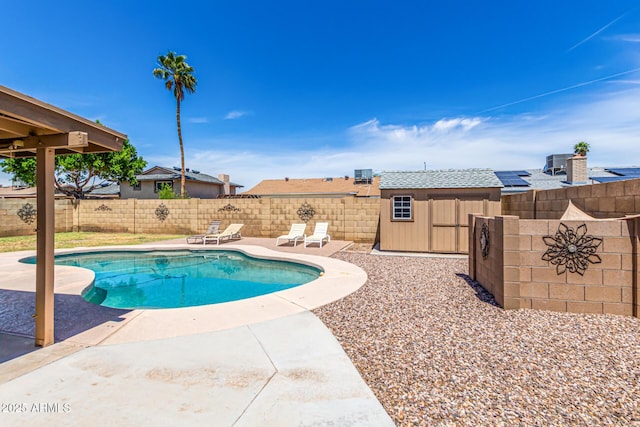 view of pool featuring an outdoor structure, central AC, a patio, a fenced backyard, and a storage shed