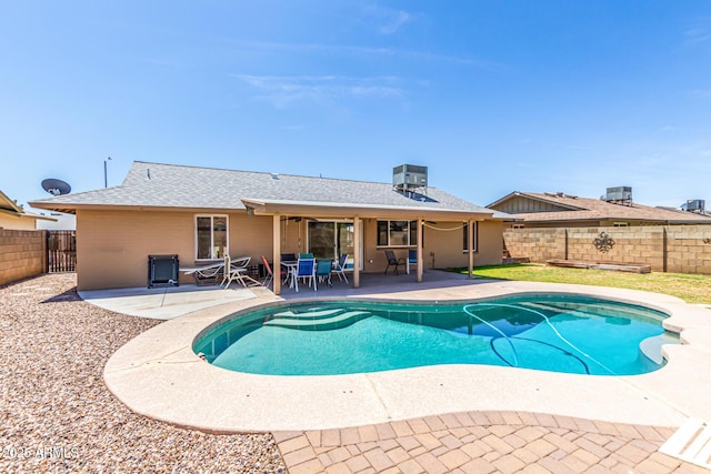 view of pool with a fenced backyard, a fenced in pool, a patio area, and central air condition unit