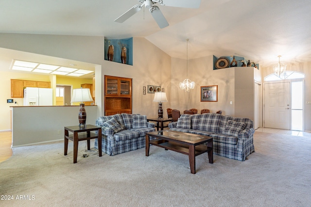 carpeted living room featuring ceiling fan with notable chandelier and high vaulted ceiling