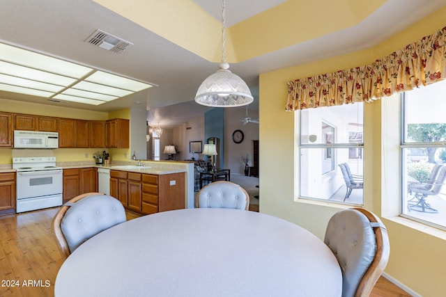 dining area with sink and light hardwood / wood-style floors