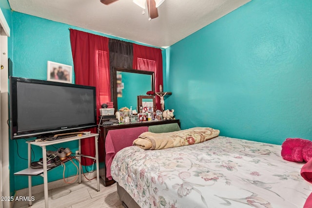 2747 E Wier Ave, Phoenix, AZ 85040 - bedroom with a ceiling fan, a textured wall, and wood finished floors