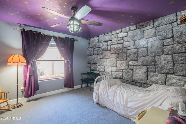 unfurnished bedroom featuring ceiling fan and carpet flooring