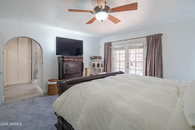 bedroom featuring french doors, wood-type flooring, and ceiling fan