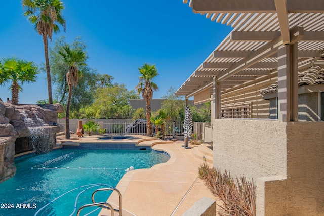 view of pool with pool water feature, a patio area, and a pergola