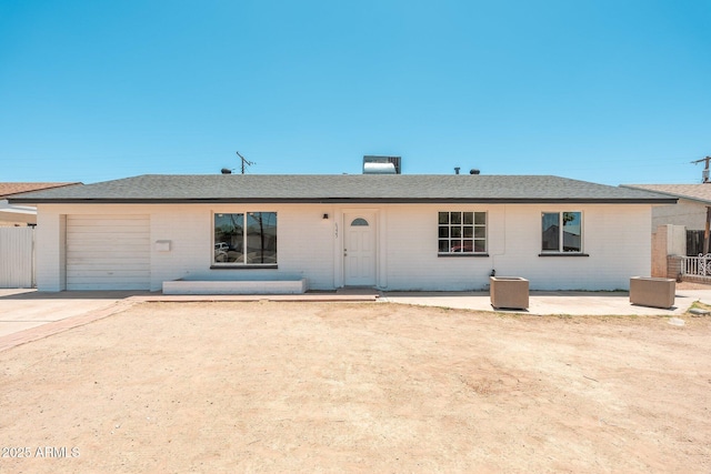 6223 W Earll Dr, Phoenix, AZ 85033 - view of front of house with an attached garage, brick siding, roof with shingles, and concrete driveway