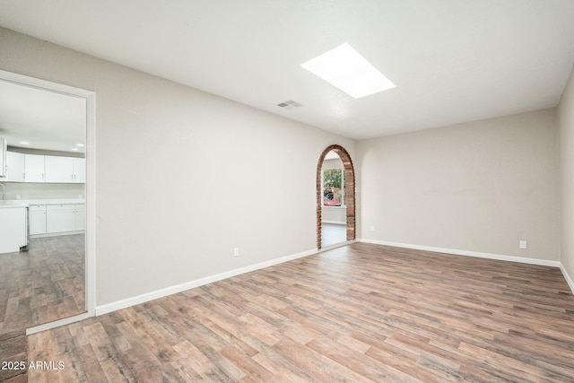 6223 W Earll Dr, Phoenix, AZ 85033 - unfurnished room with a skylight and light wood-style flooring