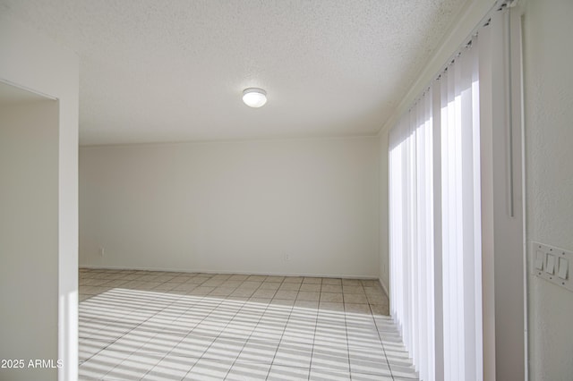 2846 N 46th Ave Unit 7, Phoenix, AZ 85035 - empty room featuring light tile patterned floors and a textured ceiling