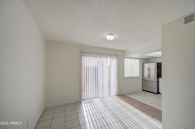 2846 N 46th Ave Unit 7, Phoenix, AZ 85035 - empty room with light tile patterned floors, a textured ceiling, and baseboards